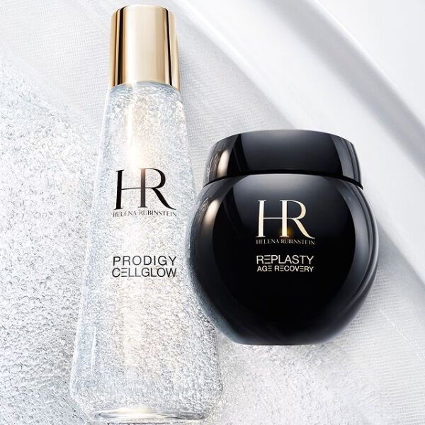 Flacon de serum Prodigy Cellglow (clair, bulles) et pot de creme Re-Plasty (noir) Helena Rubinstein. Poses sur un fond blanc texture et lumineux, symbolisant l'elegance et l'efficacite des soins.